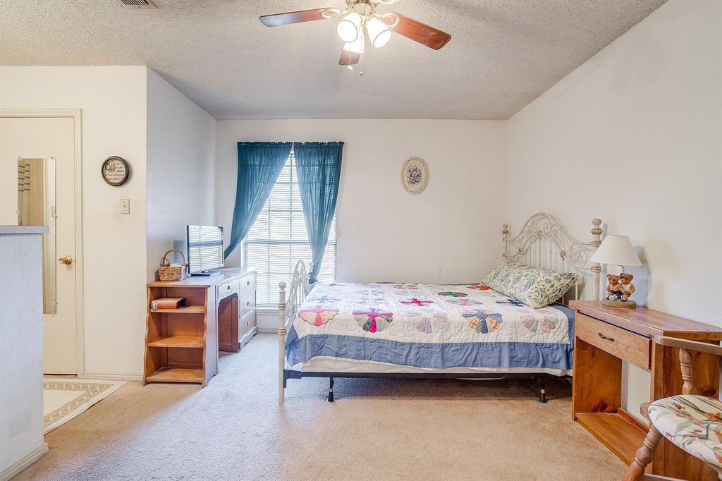 3019 Sunrise Trail Weatherford, TX 76088 - Photo 27 of 40 a bedroom with a bed and a chandelier