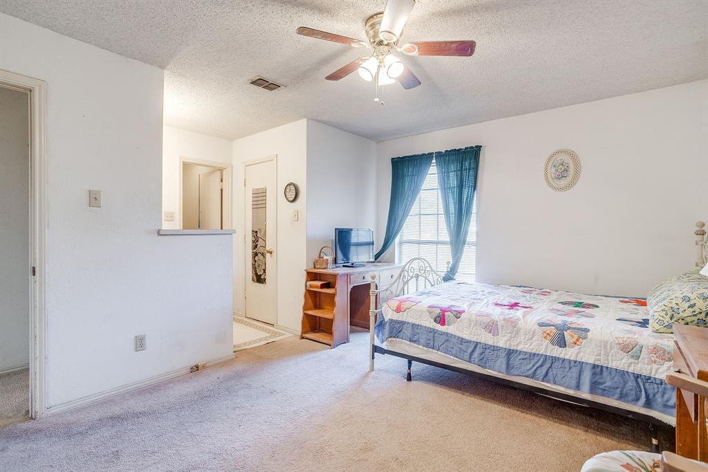 3019 Sunrise Trail Weatherford, TX 76088 - Photo 28 of 40 a bedroom with a bed and a chandelier