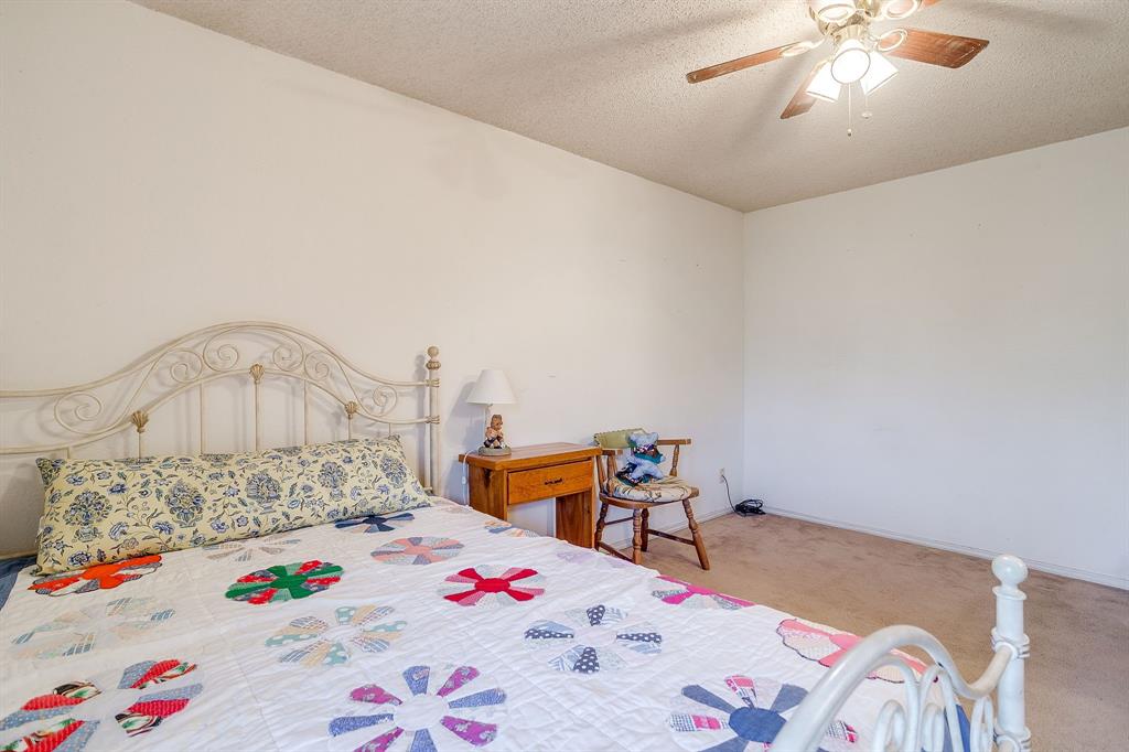 3019 Sunrise Trail Weatherford, TX 76088 - Photo 29 of 40 a bedroom with a bed and a chandelier