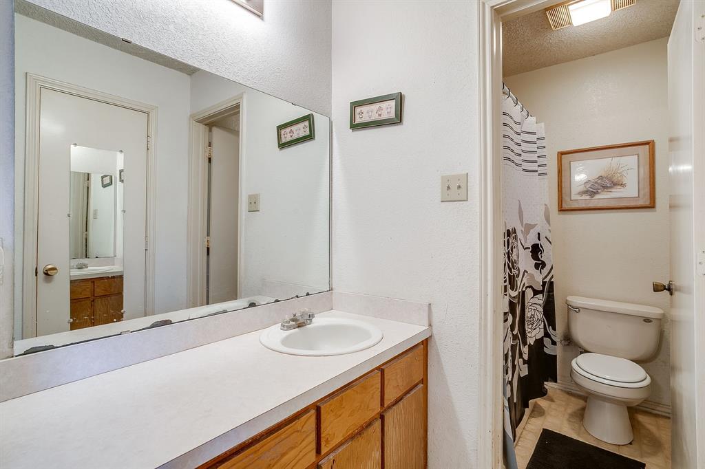 3019 Sunrise Trail Weatherford, TX 76088 - Photo 30 of 40 a bathroom with a sink toilet and a mirror