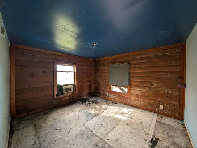 a view of empty room with a fireplace