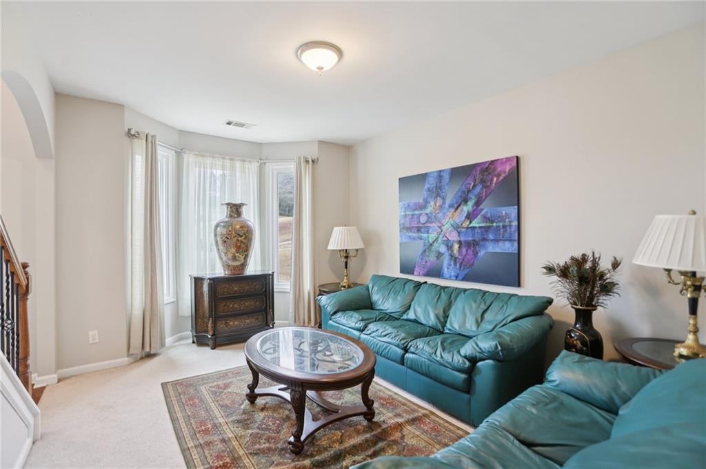 419 Long Shore Way Newnan, GA 30265 - Photo 12 of 29 a living room with furniture and a wooden floor