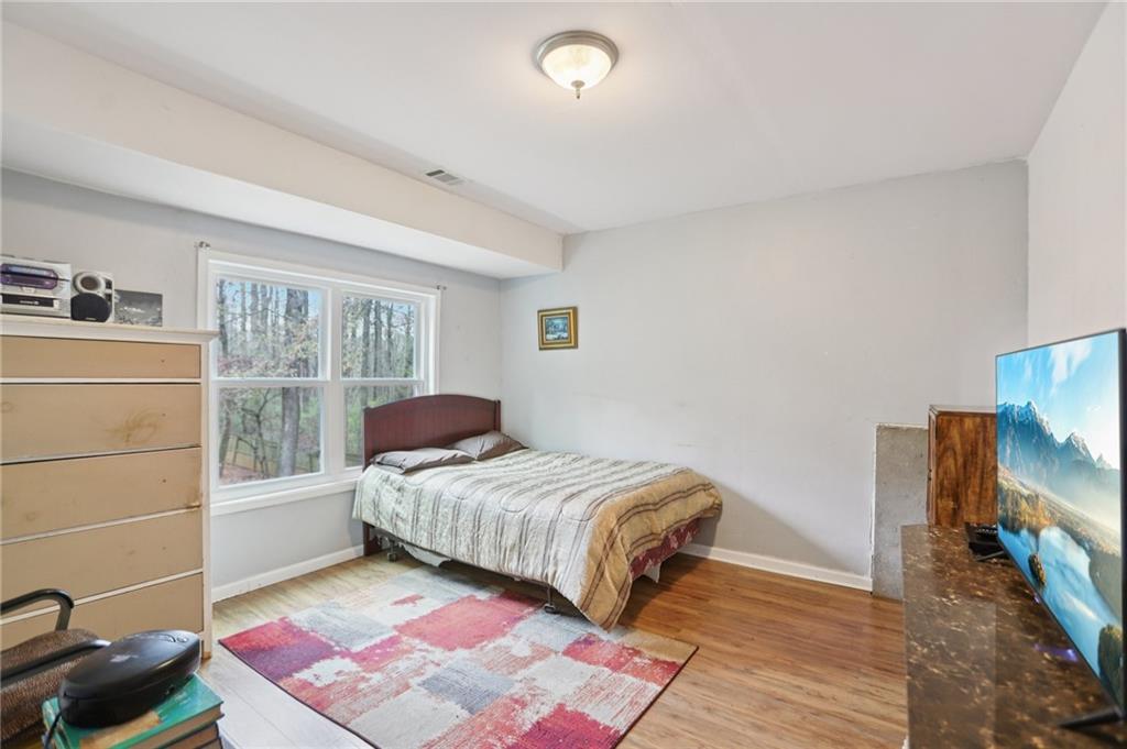 419 Long Shore Way Newnan, GA 30265 - Photo 17 of 29 a bedroom with a bed and a flat tv screen on the dresser