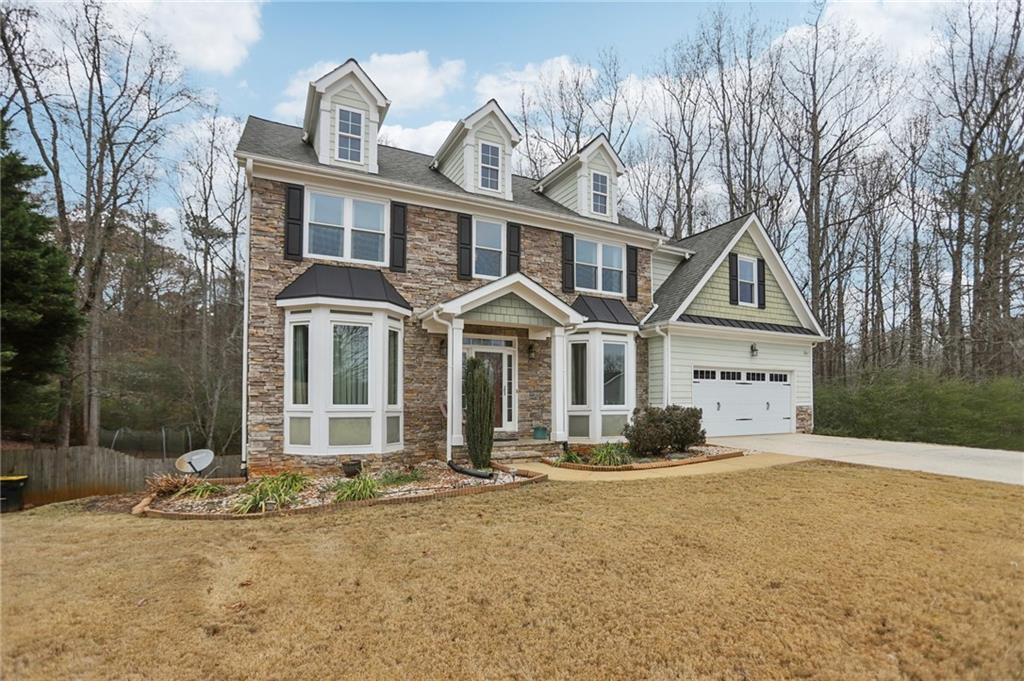 419 Long Shore Way Newnan, GA 30265 - Photo 2 of 29 a front view of a house with a yard and garage