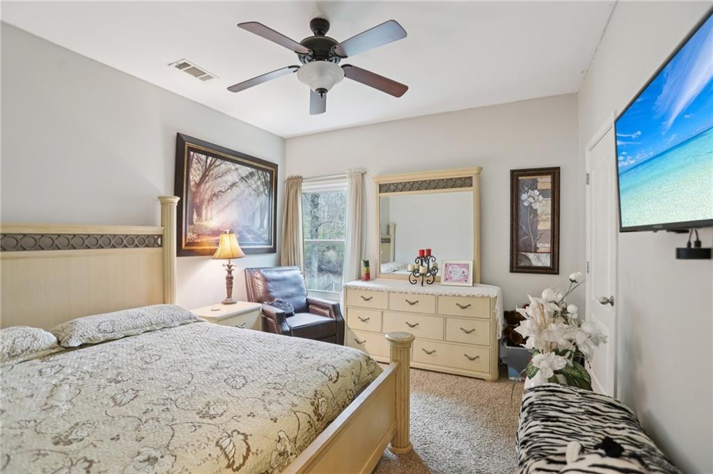 419 Long Shore Way Newnan, GA 30265 - Photo 22 of 29 a bedroom with a bed and a chandelier