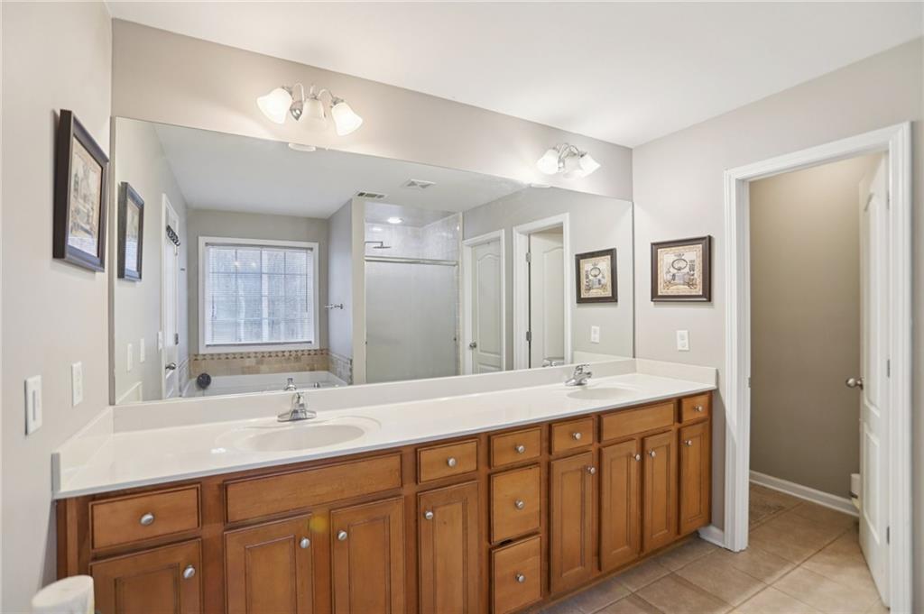 419 Long Shore Way Newnan, GA 30265 - Photo 24 of 29 a bathroom with double sink and a mirror
