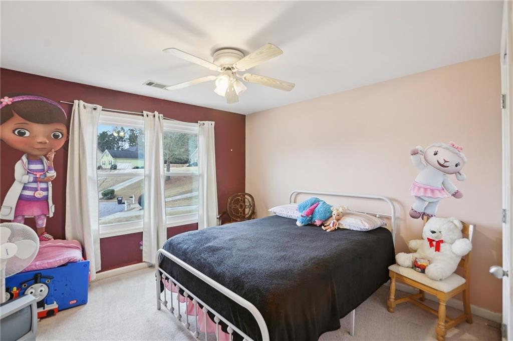 419 Long Shore Way Newnan, GA 30265 - Photo 26 of 29 a bedroom with a bed and a chandelier