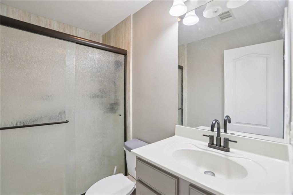419 Long Shore Way Newnan, GA 30265 - Photo 27 of 29 a bathroom with a sink vanity mirror and toilet