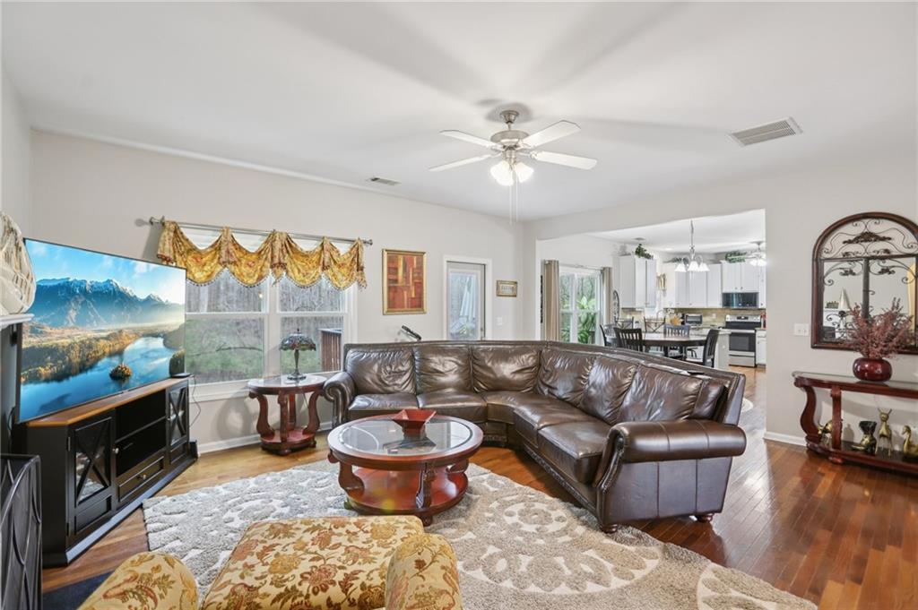 419 Long Shore Way Newnan, GA 30265 - Photo 9 of 29 a living room with furniture a flat screen tv and a large window