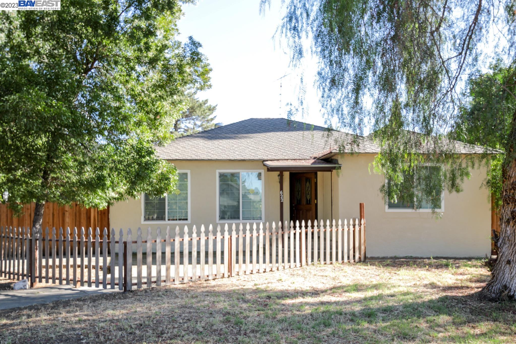 622 East Main Street Ripon, CA 95366 - Photo 1 of 1 a front view of a house with a fence