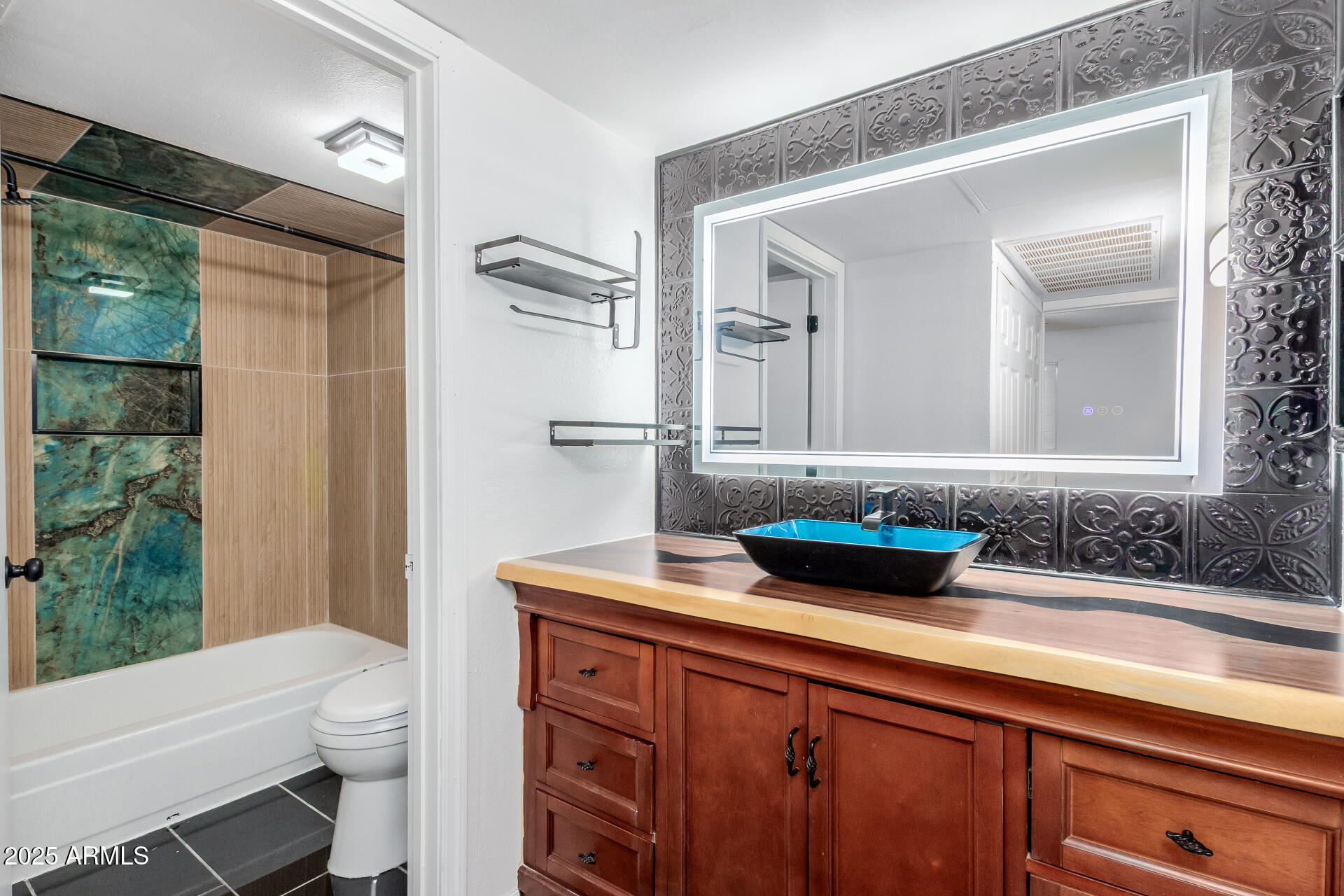 2625 East Indian School Road, Unit 238 Phoenix, AZ 85016 - Photo 11 of 29 a bathroom with a granite countertop sink a toilet a mirror and shower