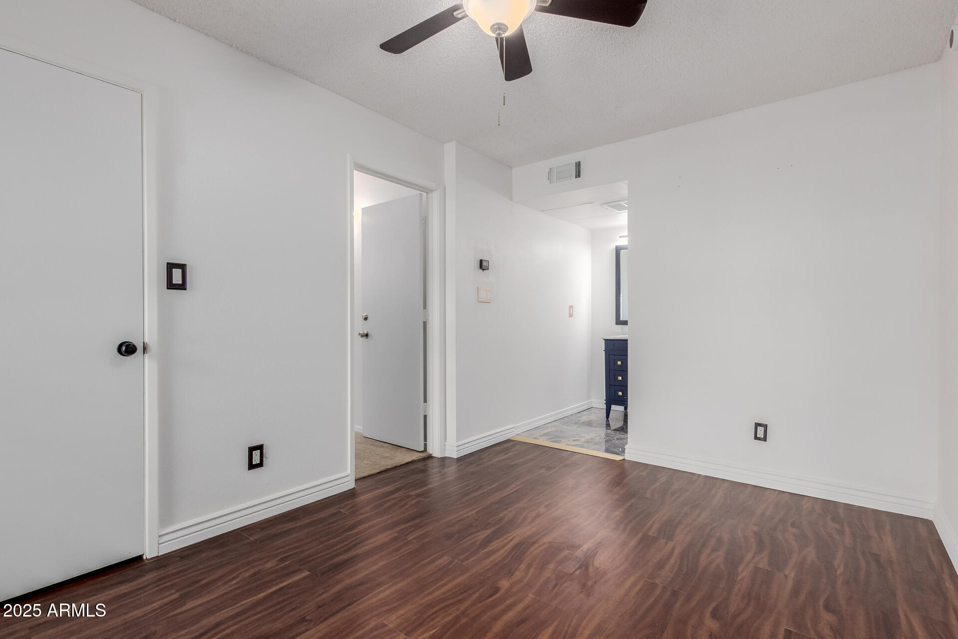2625 East Indian School Road, Unit 238 Phoenix, AZ 85016 - Photo 14 of 29 an empty room with wooden floor