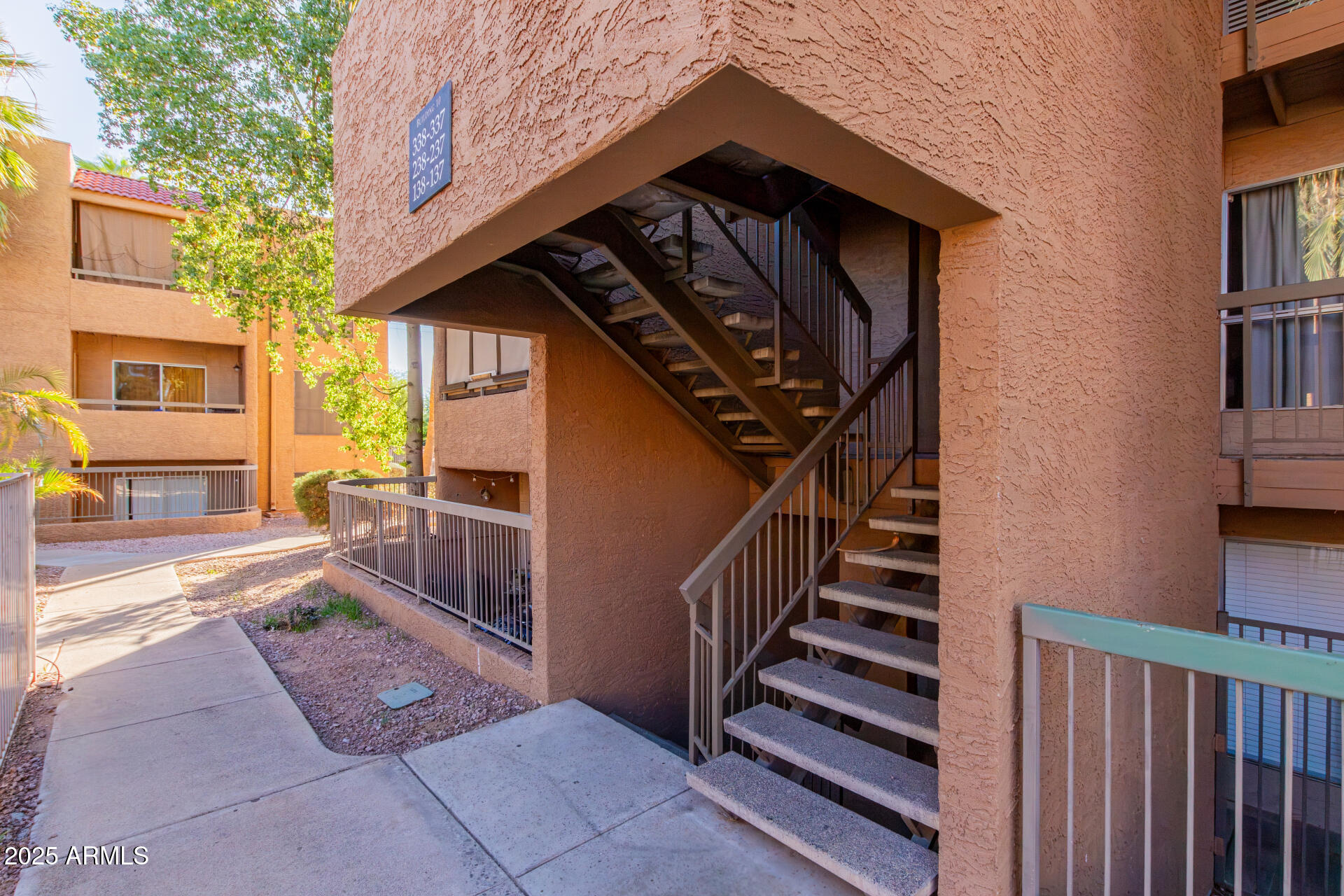 2625 East Indian School Road, Unit 238 Phoenix, AZ 85016 - Photo 22 of 29 a view of a house with a small yard and wooden fence and a large tree