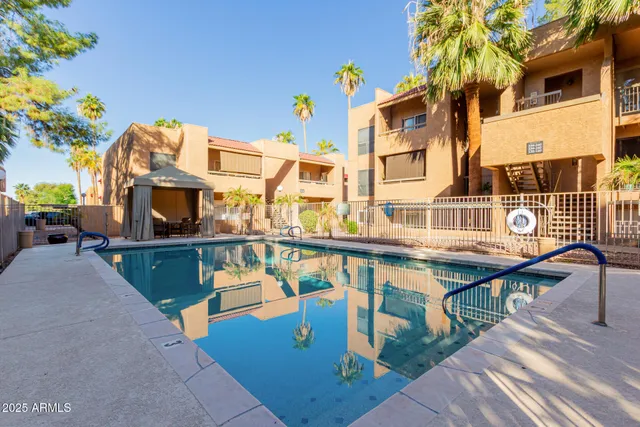 a view of a patio with table and chairs and potted plants