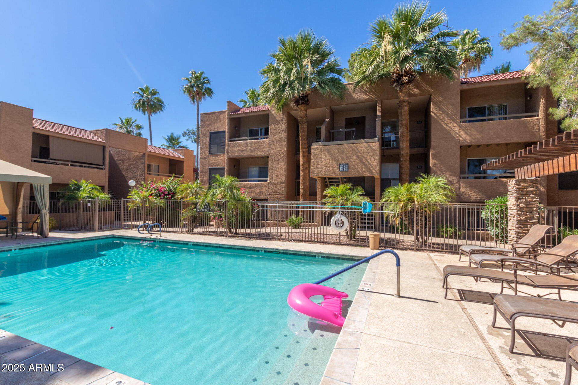 2625 East Indian School Road, Unit 238 Phoenix, AZ 85016 - Photo 25 of 29 a swimming pool with outdoor seating and yard