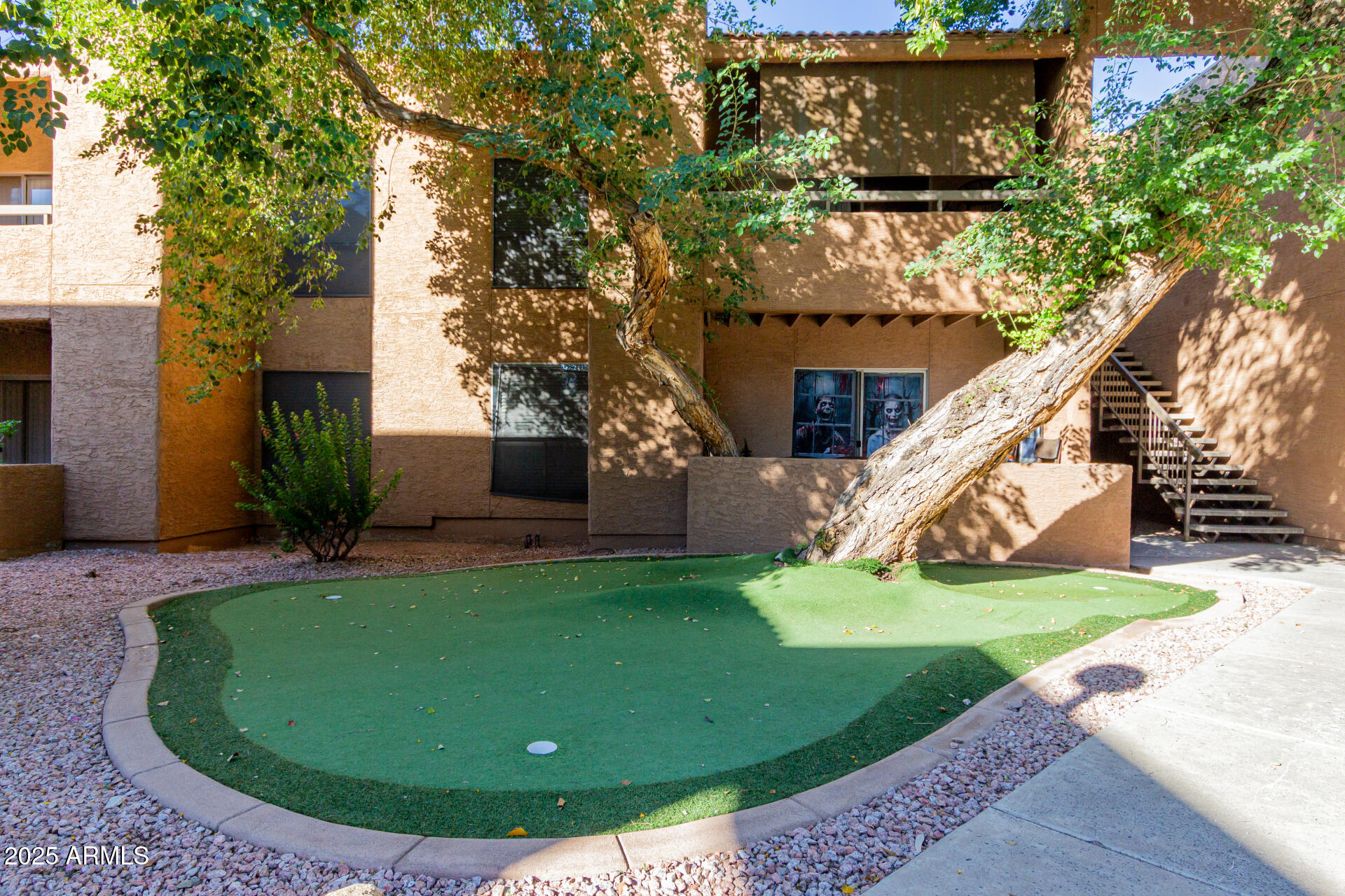 2625 East Indian School Road, Unit 238 Phoenix, AZ 85016 - Photo 28 of 29 a view of a house with a yard potted plants and a tree