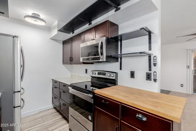 a kitchen with stainless steel appliances a stove microwave and a refrigerator