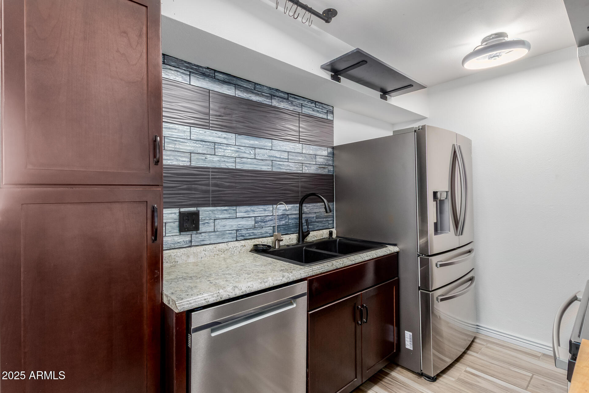 2625 East Indian School Road, Unit 238 Phoenix, AZ 85016 - Photo 7 of 29 a kitchen with stainless steel appliances granite countertop a sink and a refrigerator