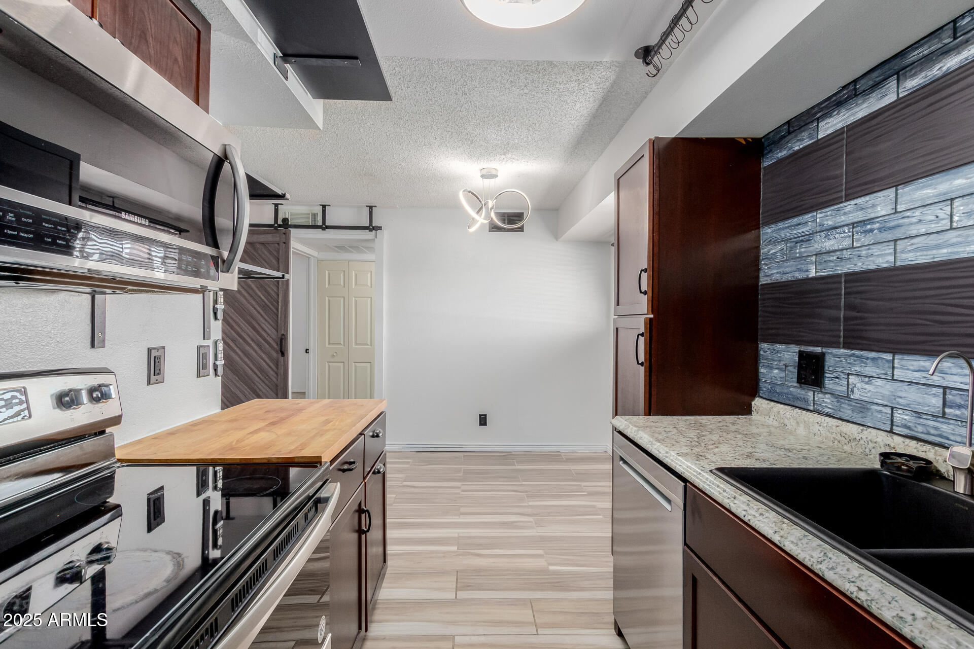 2625 East Indian School Road, Unit 238 Phoenix, AZ 85016 - Photo 8 of 29 a kitchen with a sink and refrigerator
