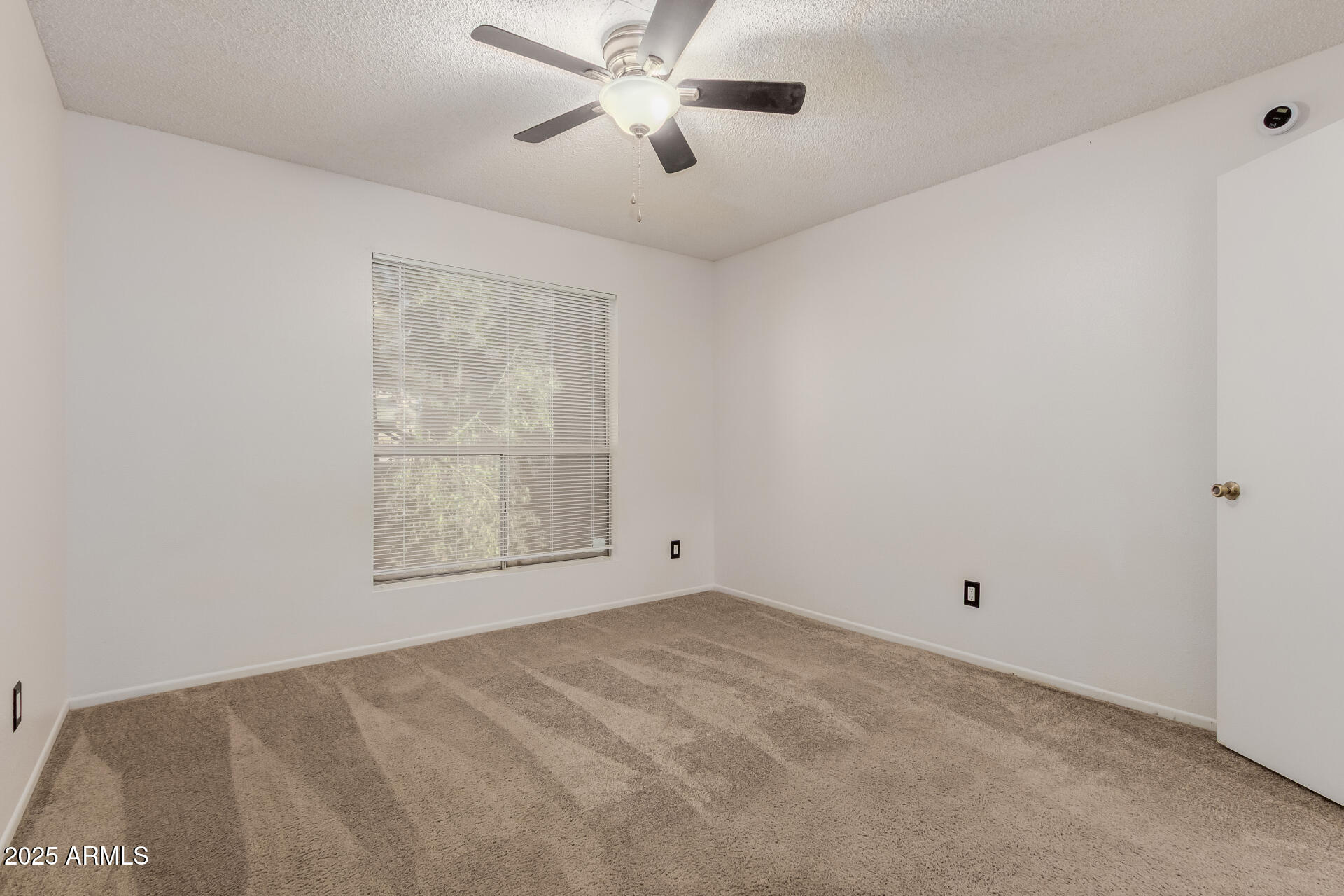 2625 East Indian School Road, Unit 238 Phoenix, AZ 85016 - Photo 9 of 29 a view of an empty room with a window
