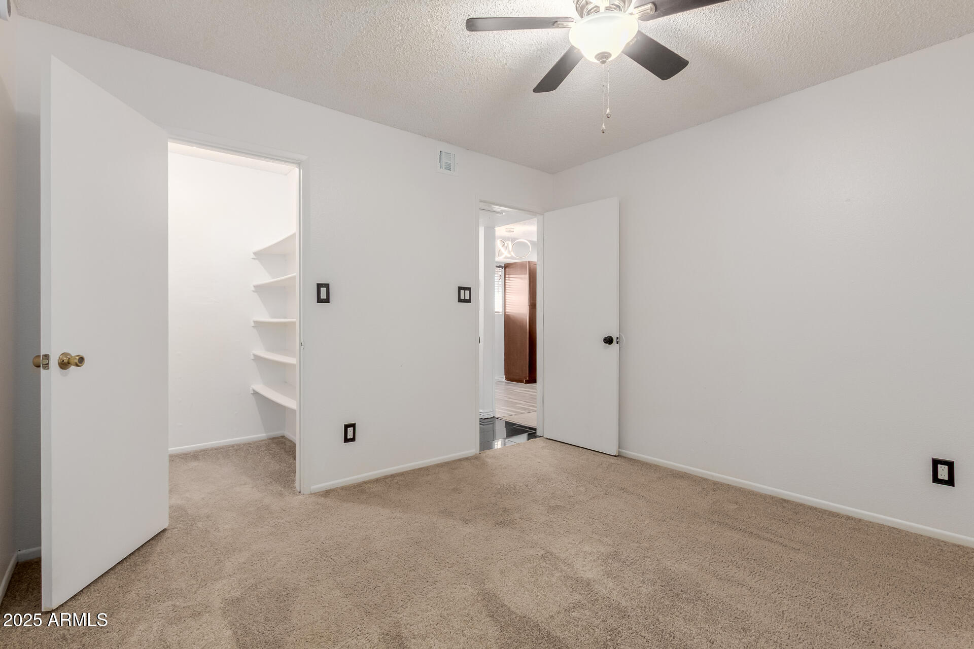 2625 East Indian School Road, Unit 238 Phoenix, AZ 85016 - Photo 10 of 29 an empty room with chandelier fan