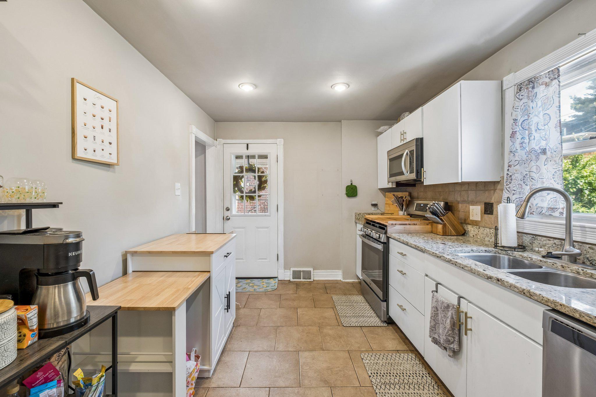 725 Hill Road Philadelphia, PA 19128 - Photo 10 of 43 a large kitchen with stainless steel appliances granite countertop a sink and cabinets