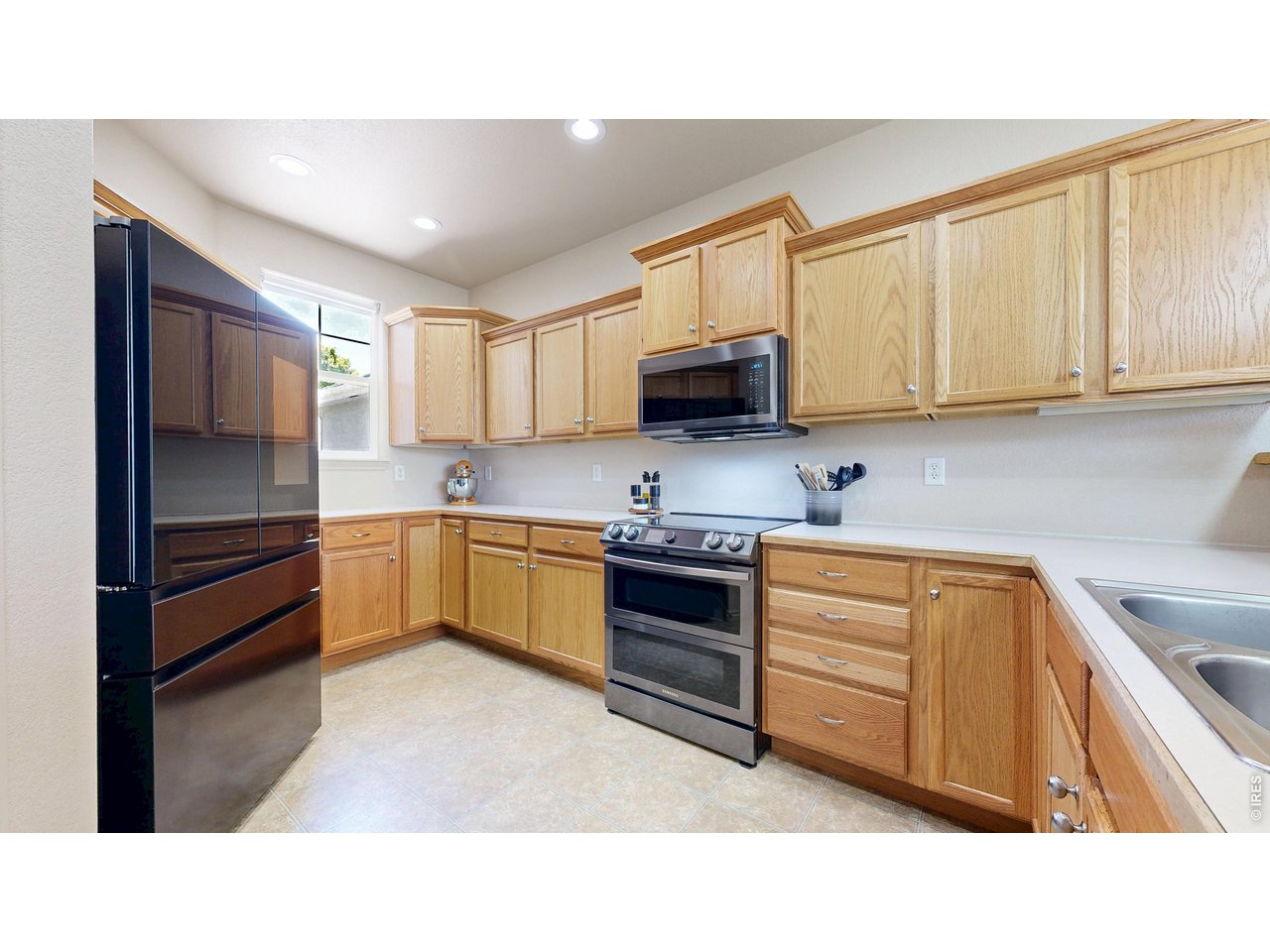 4672 West 20th Road, Unit 413 Greeley, CO 80634 - Photo 3 of 37 a kitchen with stainless steel appliances a stove sink and cabinets