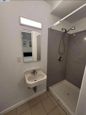 a bathroom with a sink and shower