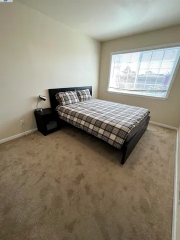 a bedroom with a bed and window