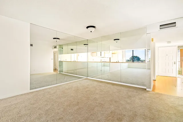 a view of a room with wooden floor and a bathroom