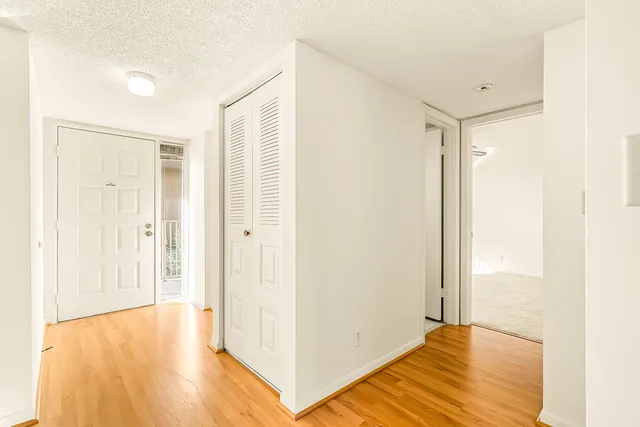 a kitchen with white cabinets and white appliances