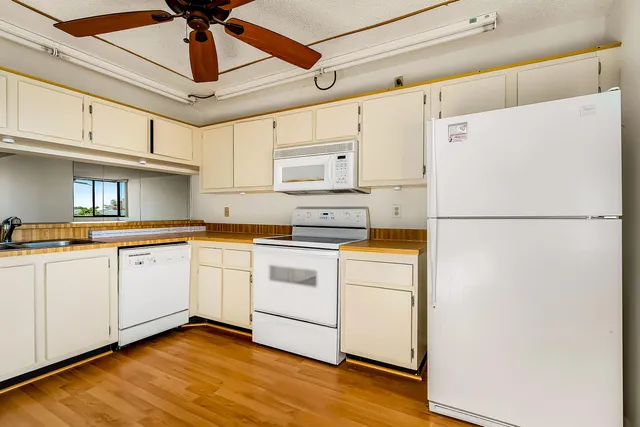 a kitchen with stainless steel appliances granite countertop a sink and cabinets