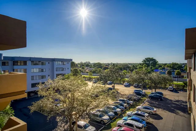 an aerial view of residential houses with outdoor space swimming pool and lake view