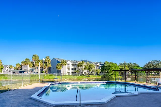 a swimming pool with outdoor seating and yard