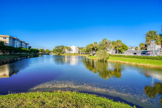 a view of swimming pool with outdoor seating and city view