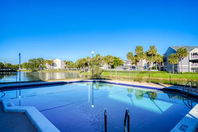 swimming pool view with a garden space