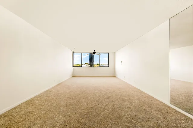 a view of an empty room with a large window