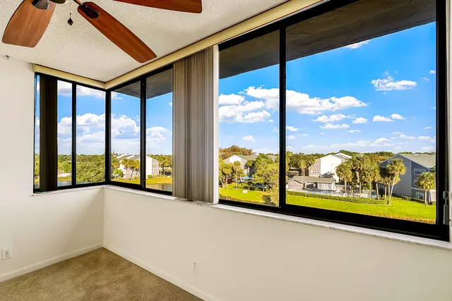 a view of a room with window and ceiling fan