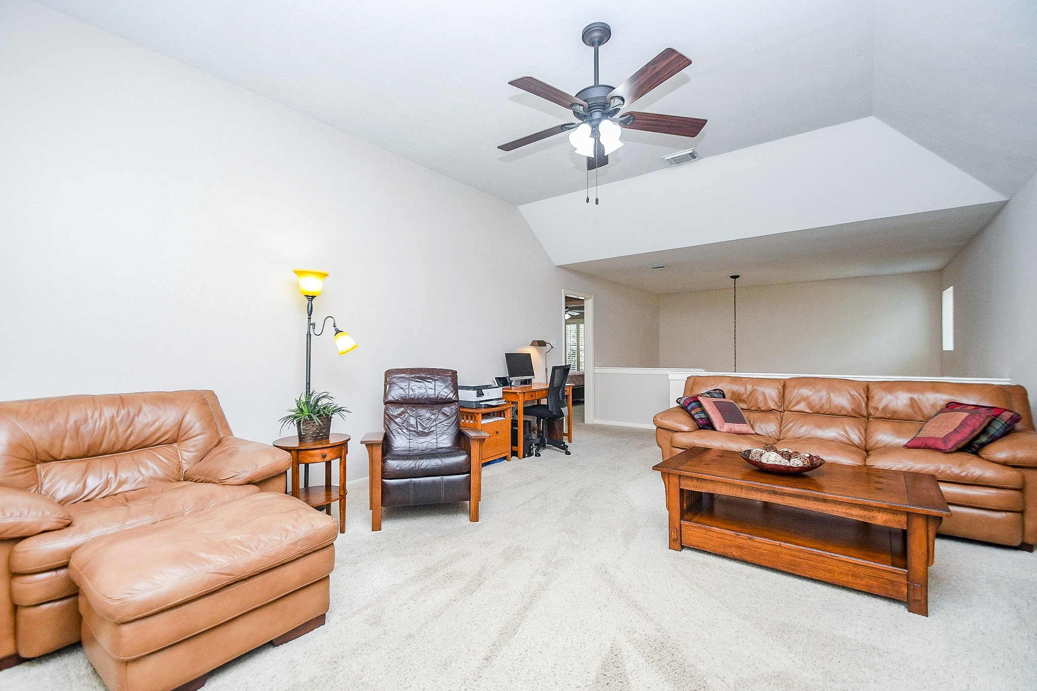1703 Fall Ridge Circle Katy, TX 77494 - Photo 24 of 38 At the top of the stairs you will find a massive gameroom with a vaulted ceiling. The stairs are located behind the couch.