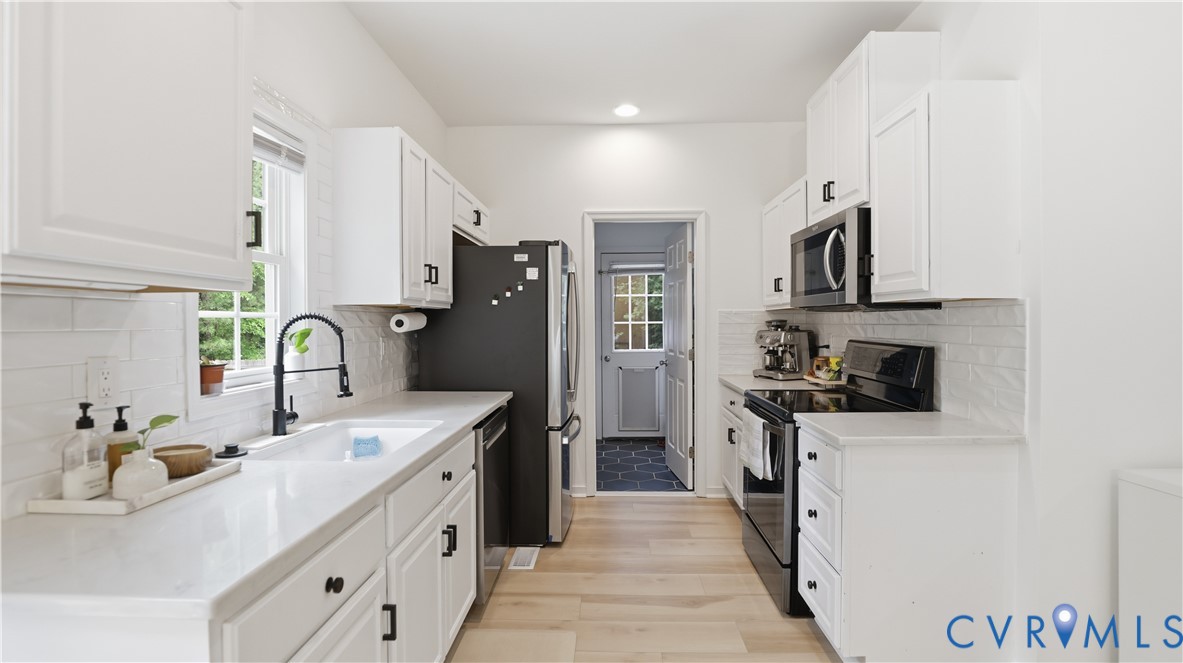 2406 Emanuel Church Road Powhatan, VA 23139 - Photo 13 of 48 Galley kitchen featuring white cabinetry, light co