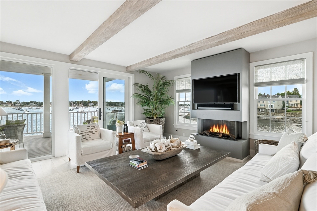 131 Front Street Marblehead, MA 01945 - Photo 12 of 41 a living room with furniture a flat screen tv and a fireplace