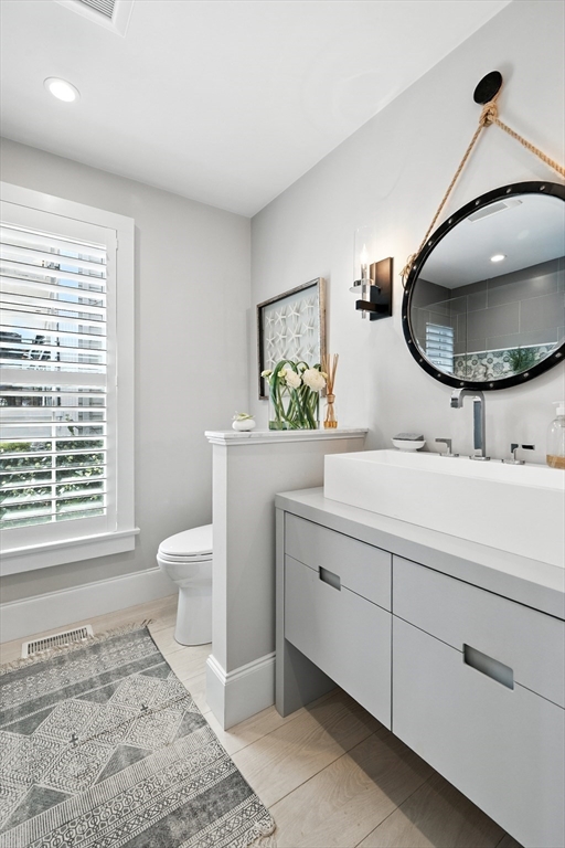 131 Front Street Marblehead, MA 01945 - Photo 15 of 41 a bathroom with a toilet sink and mirror