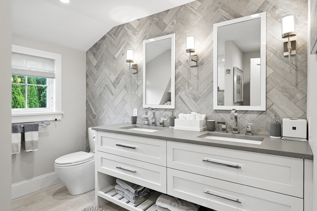 131 Front Street Marblehead, MA 01945 - Photo 26 of 41 a bathroom with a granite countertop toilet sink and a mirror
