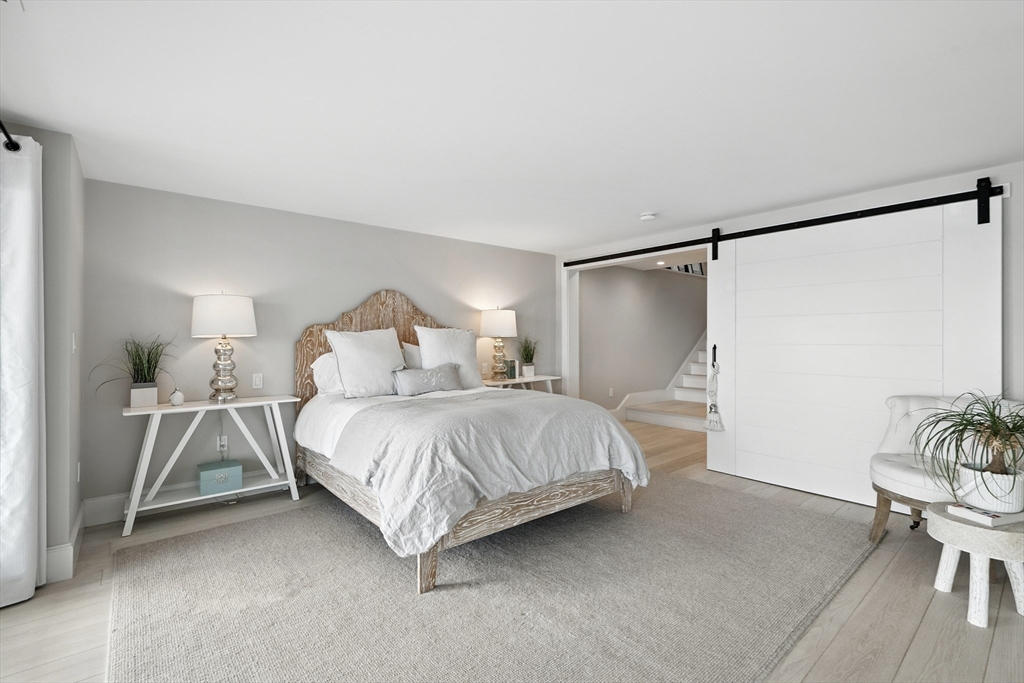 131 Front Street Marblehead, MA 01945 - Photo 28 of 41 a bedroom with a bed and a table in it