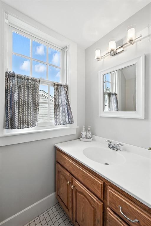 131 Front Street Marblehead, MA 01945 - Photo 36 of 41 a bathroom with a sink and a mirror