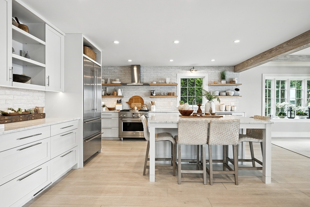 131 Front Street Marblehead, MA 01945 - Photo 9 of 41 a kitchen with a table chairs stove and cabinets