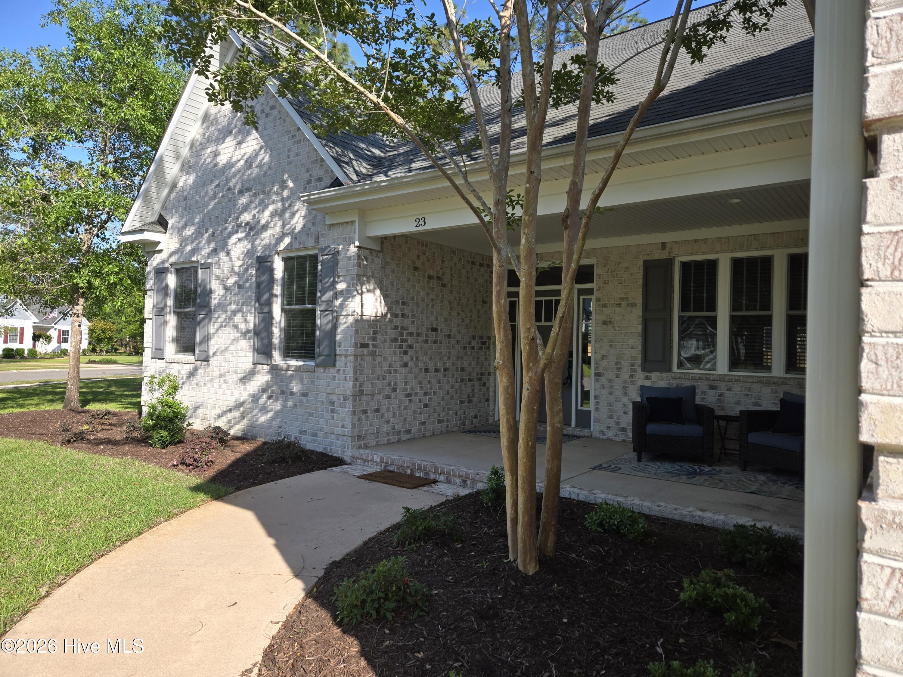 23 Stonegate Circle Hampstead, NC 28443 - Photo 20 of 69 Concrete walkway leading to the front door and inviting front porch