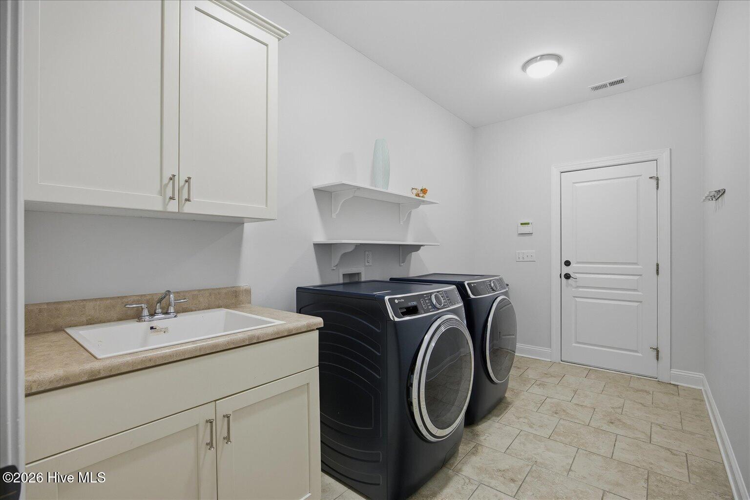 23 Stonegate Circle Hampstead, NC 28443 - Photo 36 of 64 Come in from the beach or pool and drop your sandy items here in the Mud Room. Convenient Laundry Room leading from the garage. Washer/Dryer Convey with the property