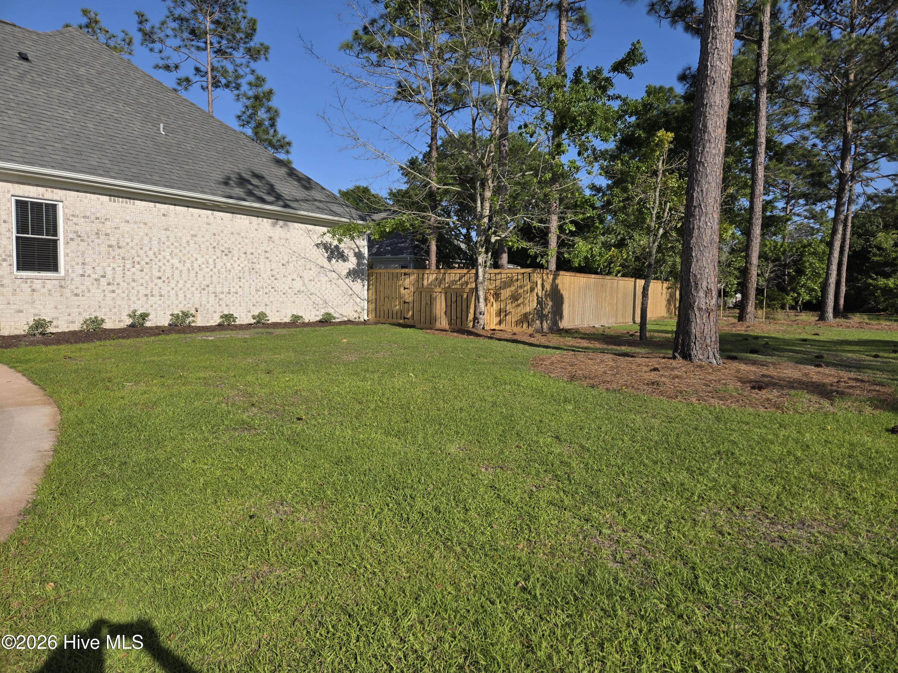 23 Stonegate Circle Hampstead, NC 28443 - Photo 41 of 64 Right side of the home. Property extends outside of the new privacy fence towards the cul-de-sac