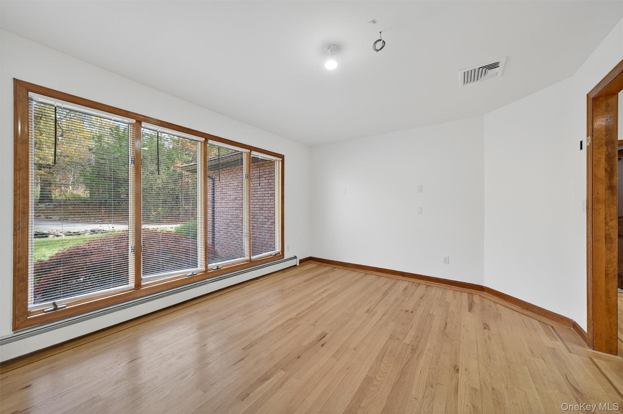 220 Oxford Road Chester, NY 10918 - Photo 17 of 50 a view of an empty room with wooden floor and a window
